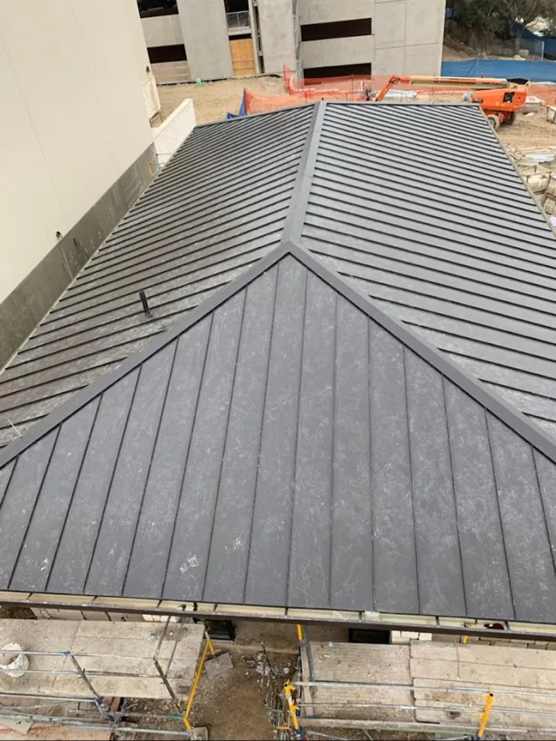 Commercial metal roof construction with crane equipment in Ellisville