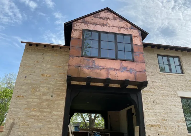 Copper metal panel facade on a stone building for Skylight Installation in Ellisville